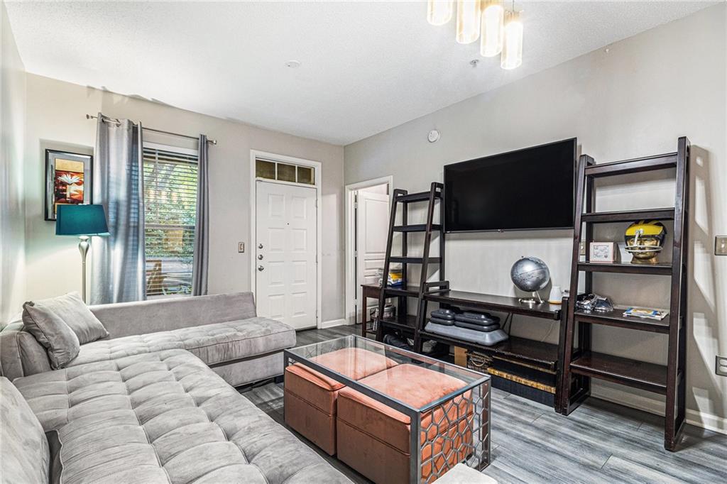 10 Perimeter Summit Boulevard, Unit 4131 Atlanta, GA 30319 - Photo 13 of 30 a living room with furniture and a flat screen tv