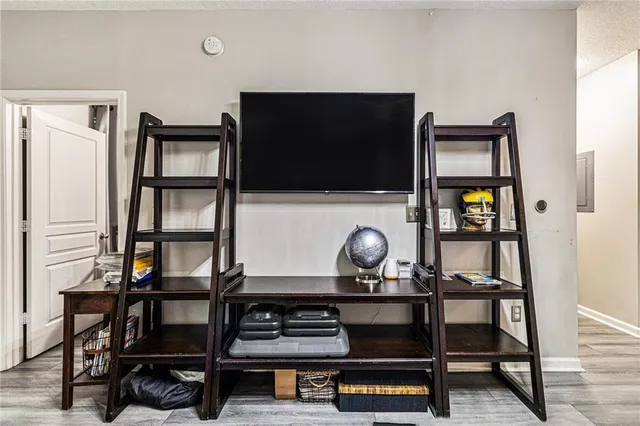 a living room with chair and a flat screen tv