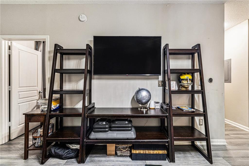 10 Perimeter Summit Boulevard, Unit 4131 Atlanta, GA 30319 - Photo 14 of 30 a living room with chair and a flat screen tv