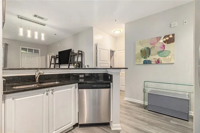 a kitchen with stainless steel appliances granite countertop a sink and a stove top oven