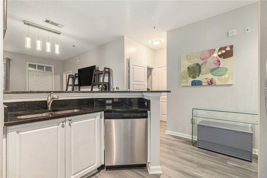 10 Perimeter Summit Boulevard, Unit 4131 Atlanta, GA 30319 - Photo 19 of 30 a kitchen with stainless steel appliances granite countertop a sink and a stove top oven