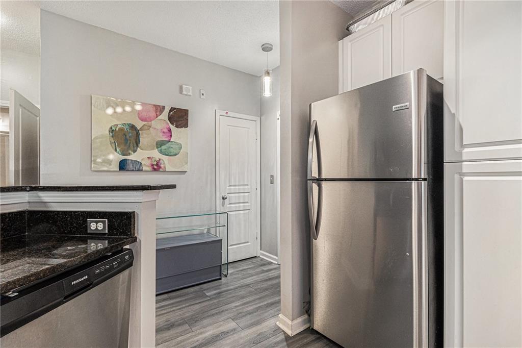 10 Perimeter Summit Boulevard, Unit 4131 Atlanta, GA 30319 - Photo 20 of 30 a kitchen with stainless steel appliances granite countertop a refrigerator and a stove top oven