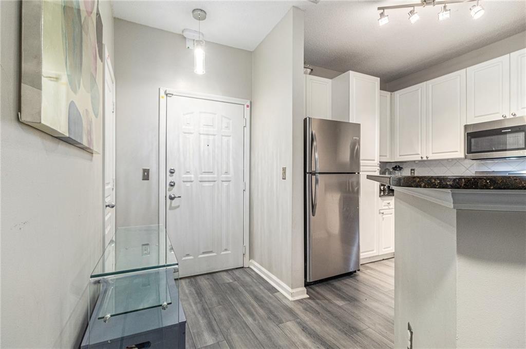 10 Perimeter Summit Boulevard, Unit 4131 Atlanta, GA 30319 - Photo 21 of 30 a kitchen with stainless steel appliances granite countertop a refrigerator and a stove