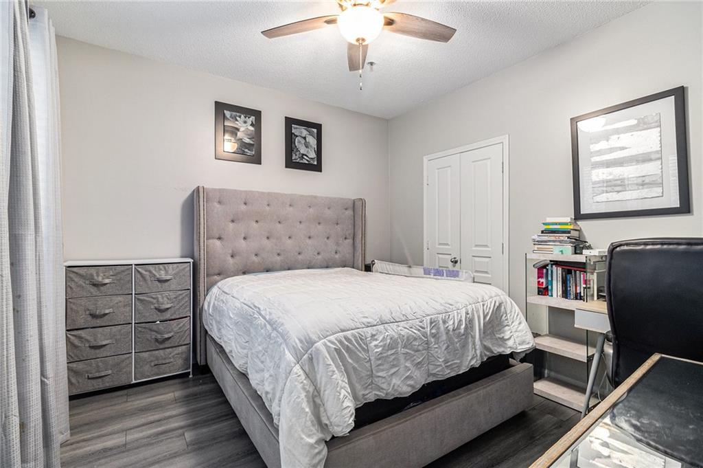 10 Perimeter Summit Boulevard, Unit 4131 Atlanta, GA 30319 - Photo 24 of 30 a bedroom with a bed and a dresser