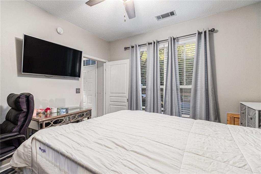 10 Perimeter Summit Boulevard, Unit 4131 Atlanta, GA 30319 - Photo 25 of 30 a bedroom with a bed and a flat screen tv