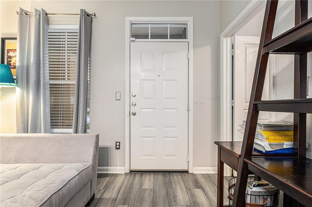 10 Perimeter Summit Boulevard, Unit 4131 Atlanta, GA 30319 - Photo 10 of 30 a living room with a bed and a flat tv screen on dresser