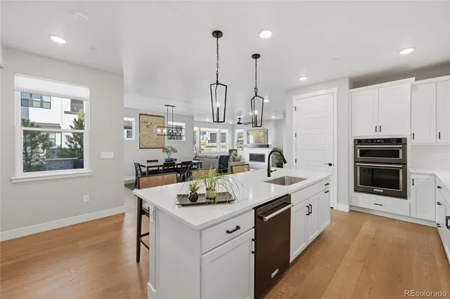 a kitchen with stainless steel appliances kitchen island granite countertop a stove a sink and a refrigerator