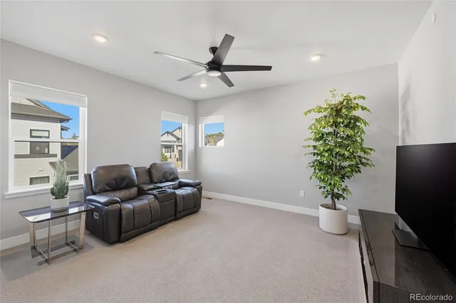a living room with furniture and a potted plant