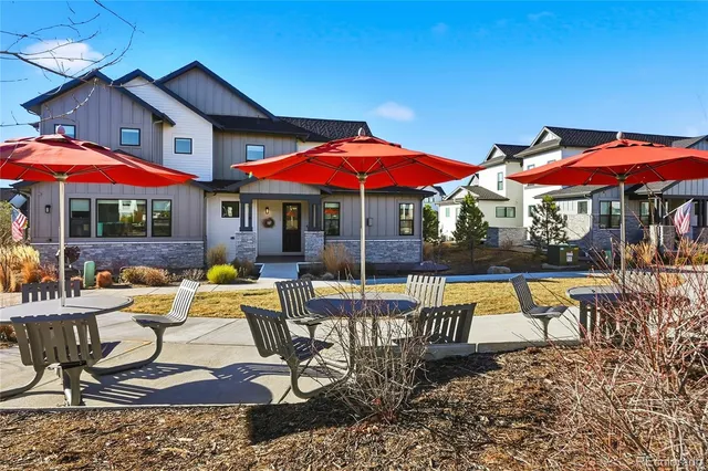 a view of a patio with chairs and umbrellas
