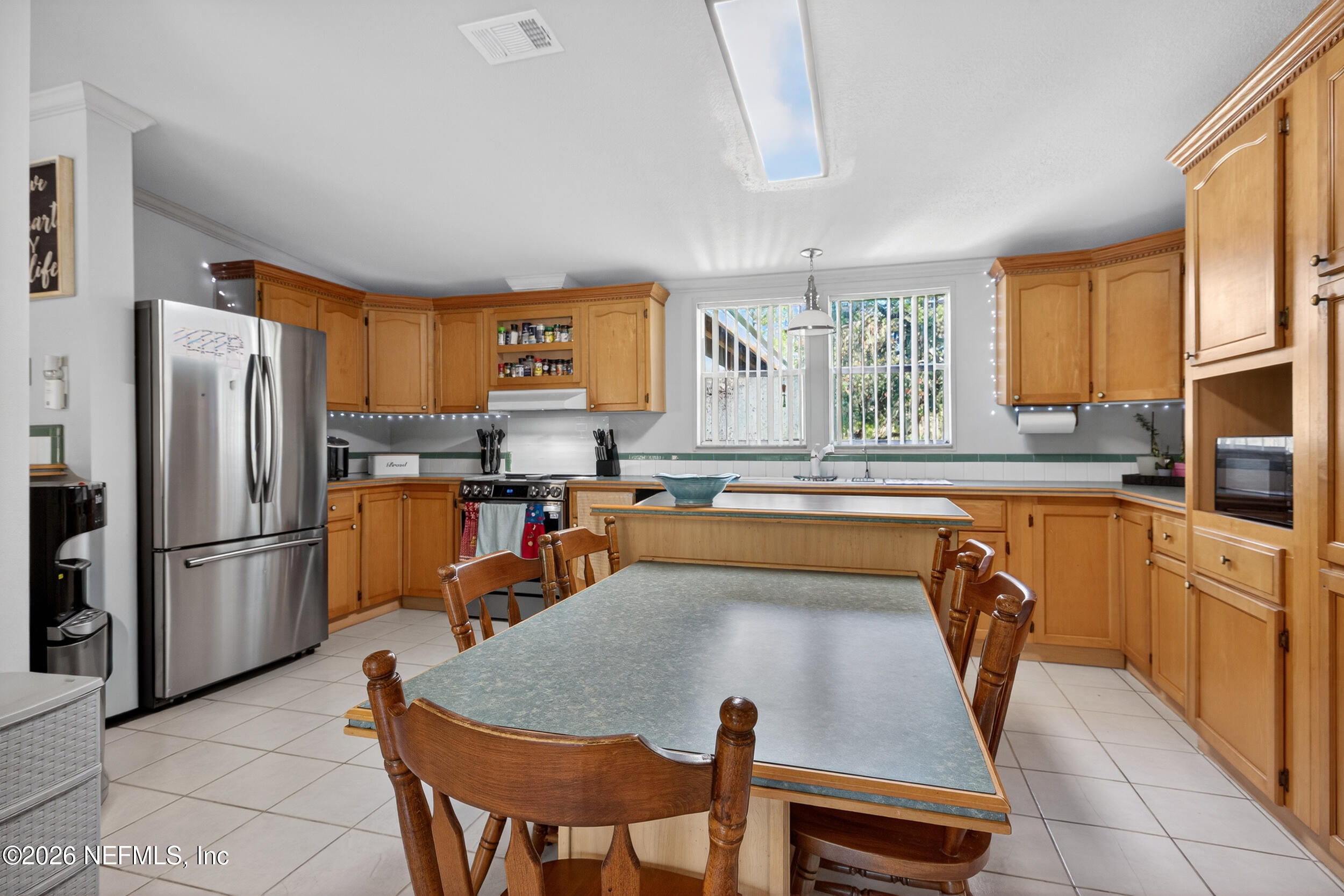 1755 Bennett Road St. Augustine, FL 32092 - Photo 11 of 34 a kitchen with stainless steel appliances granite countertop a refrigerator a sink a stove and white cabinets