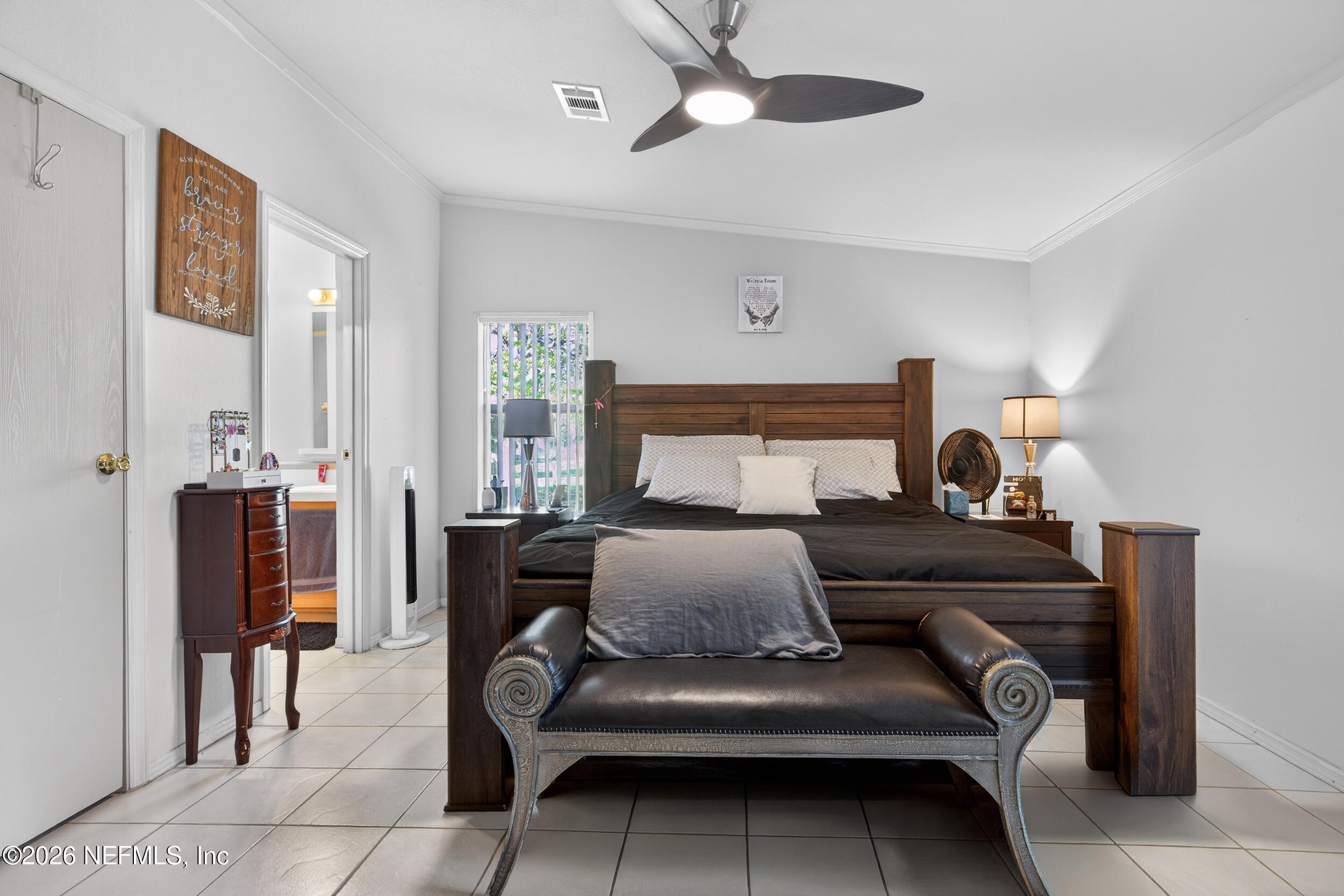 1755 Bennett Road St. Augustine, FL 32092 - Photo 15 of 34 a bedroom with furniture and a chandelier