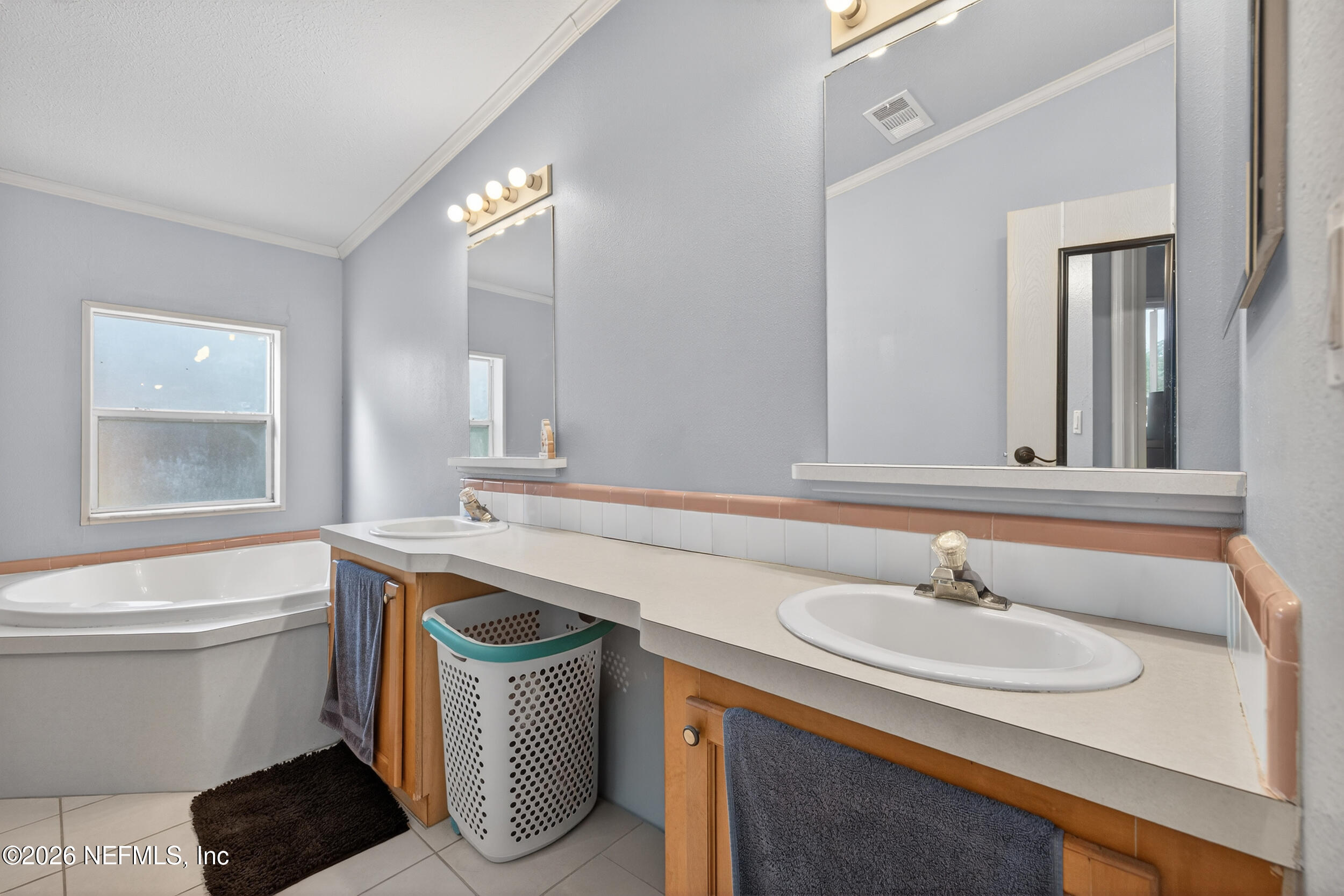 1755 Bennett Road St. Augustine, FL 32092 - Photo 17 of 34 a bathroom with a sink a toilet a mirror and bathtub
