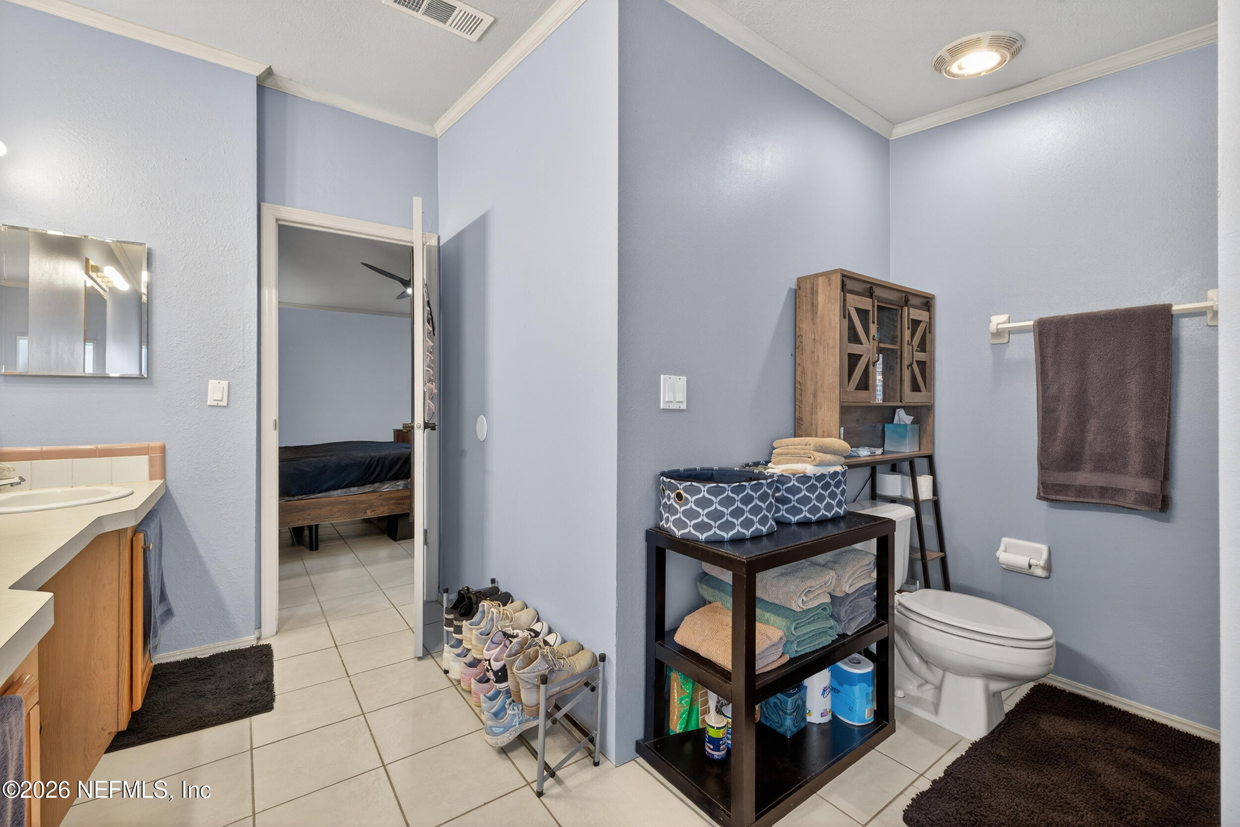 1755 Bennett Road St. Augustine, FL 32092 - Photo 18 of 34 a bathroom with a toilet a sink and a mirror