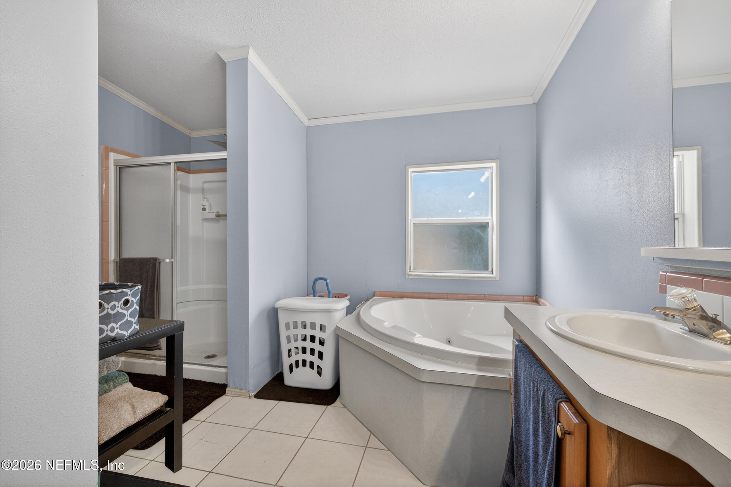 1755 Bennett Road St. Augustine, FL 32092 - Photo 19 of 34 a bathroom with a sink a bathtub and a mirror