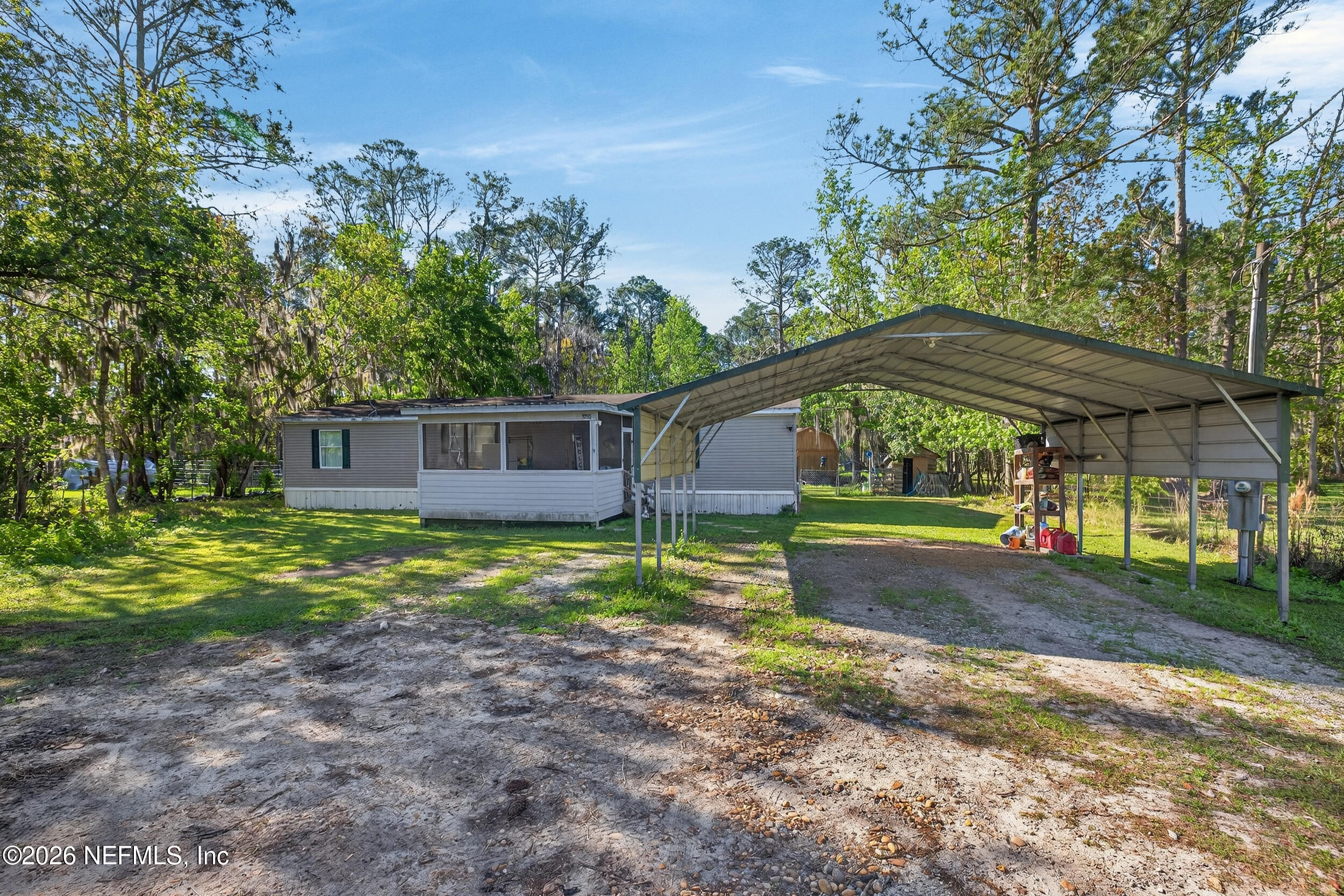 1755 Bennett Road St. Augustine, FL 32092 - Photo 4 of 34 a view of a house with backyard and trees