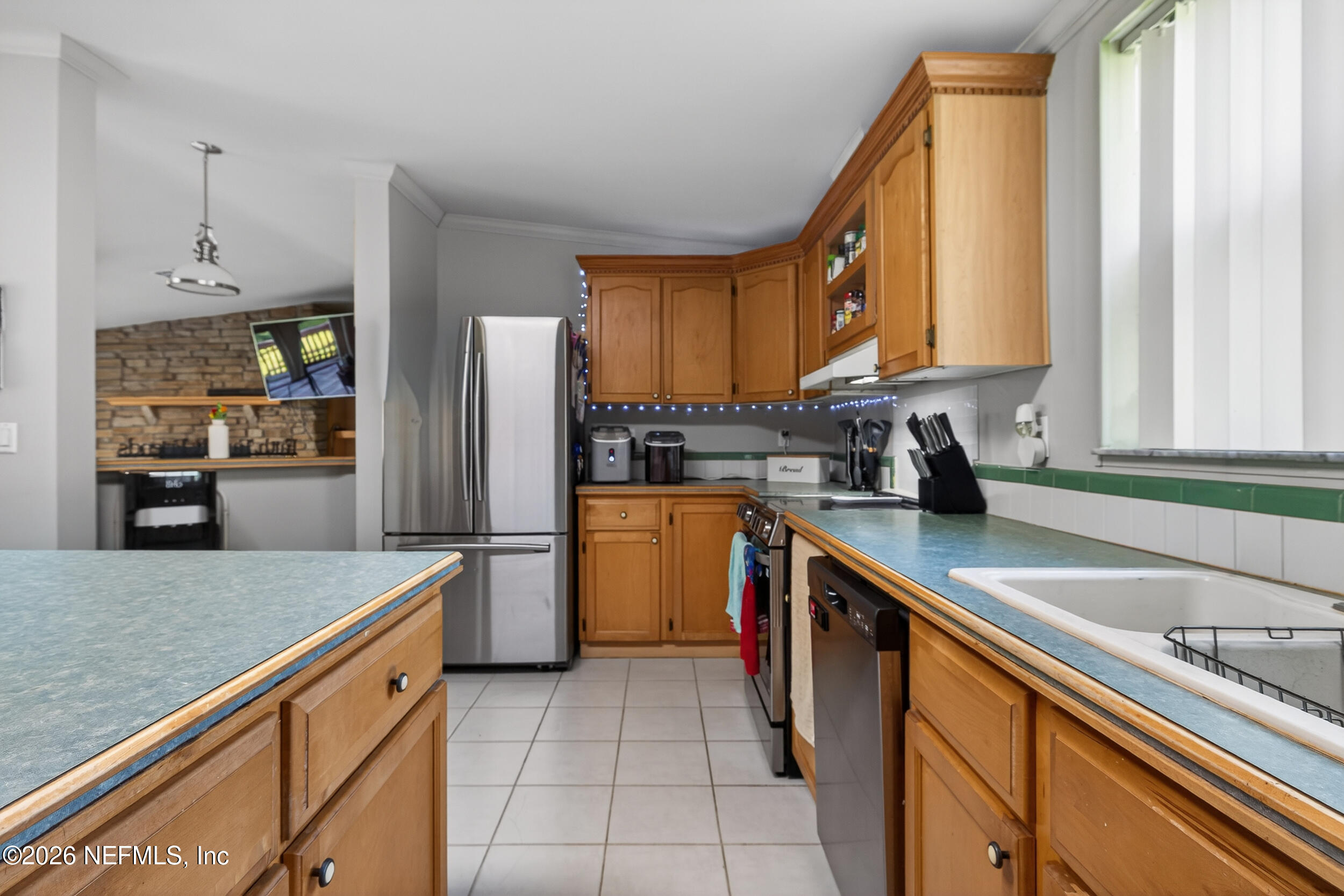 1755 Bennett Road St. Augustine, FL 32092 - Photo 8 of 34 a kitchen with a sink a counter top space cabinets stainless steel appliances and a window