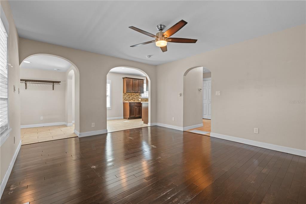222 25th Street North St. Petersburg, FL 33713 - Photo 11 of 32 a view of an empty room with wooden floor and a ceiling fan