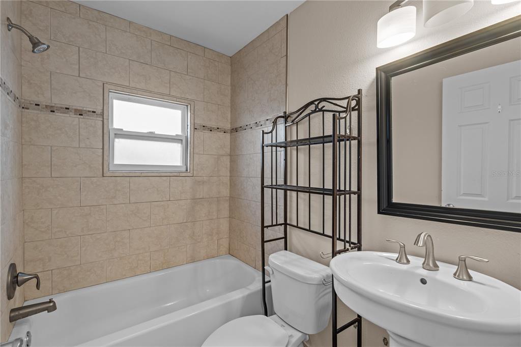 222 25th Street North St. Petersburg, FL 33713 - Photo 16 of 32 a bathroom with a sink toilet and shower
