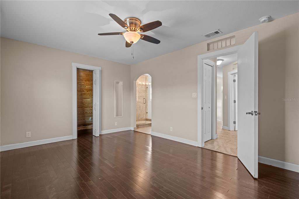222 25th Street North St. Petersburg, FL 33713 - Photo 20 of 32 an empty room with wooden floor and a ceiling fan