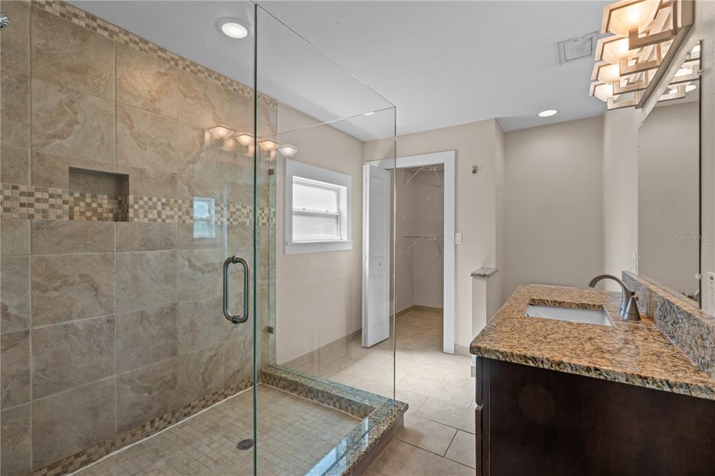222 25th Street North St. Petersburg, FL 33713 - Photo 22 of 32 a bathroom with a granite countertop sink mirror and shower