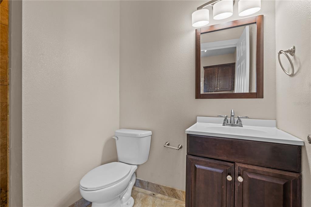 222 25th Street North St. Petersburg, FL 33713 - Photo 30 of 32 a bathroom with a toilet sink vanity and mirror