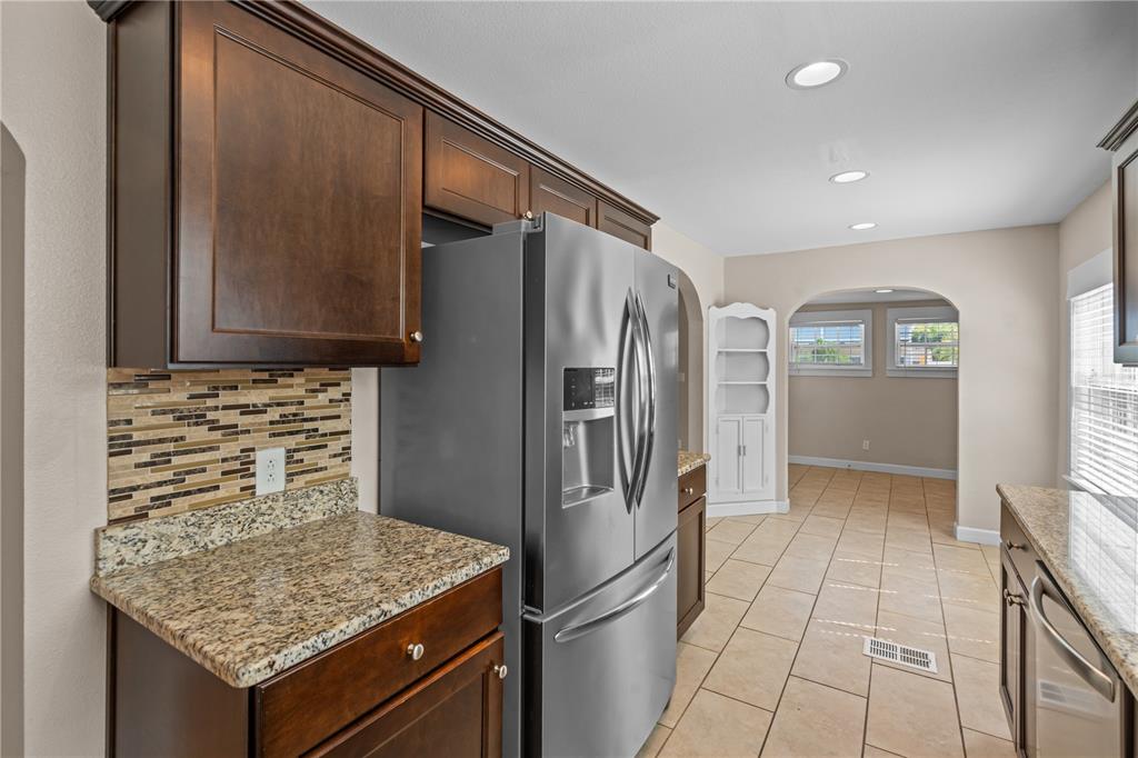 222 25th Street North St. Petersburg, FL 33713 - Photo 9 of 32 a kitchen with stainless steel appliances granite countertop a refrigerator and a sink