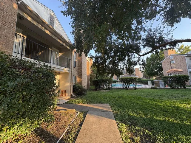 a backyard of a house with table and chairs