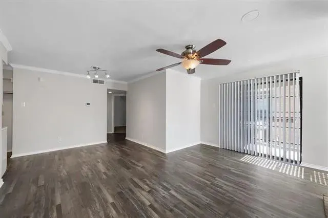 wooden floor in an empty room with a window