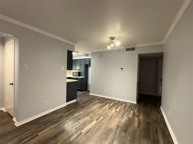a view of a kitchen with a sink and a refrigerator
