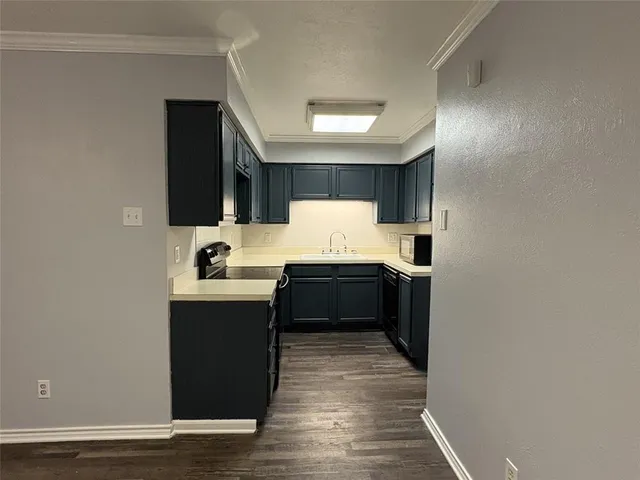 a large kitchen with a stove and a refrigerator