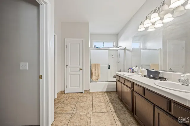 a bathroom with a sink a mirror and a shower