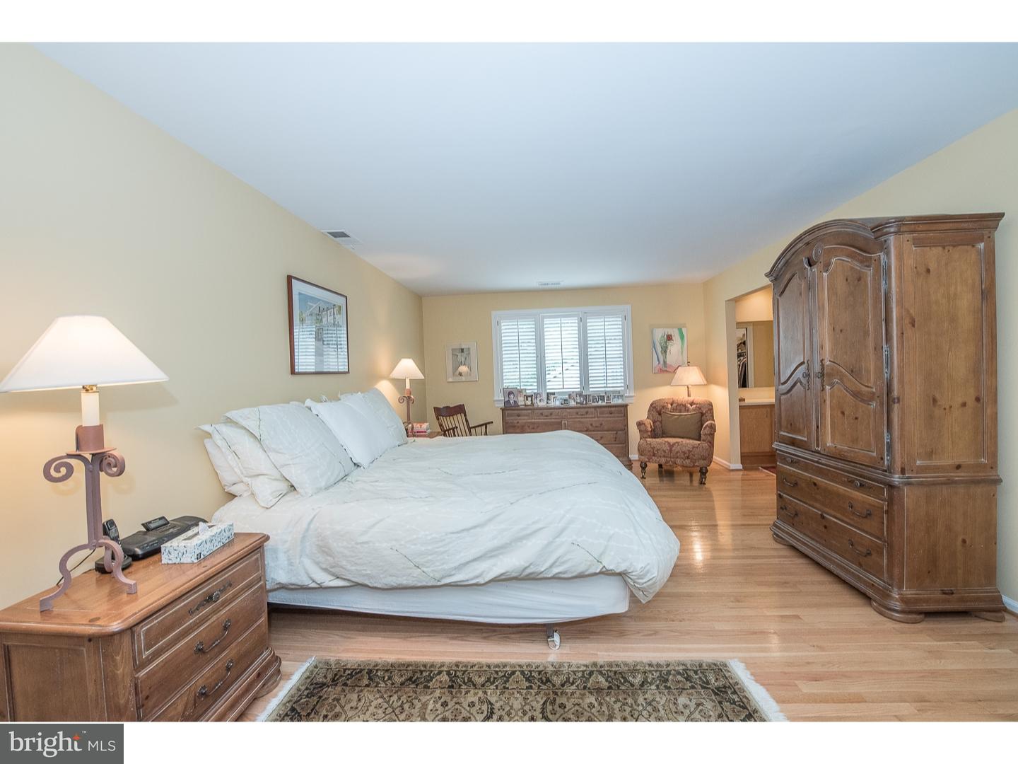 414 Gilpin Road Narberth, PA 19072 - Photo 16 of 25 a bedroom with a bed lamp and dresser