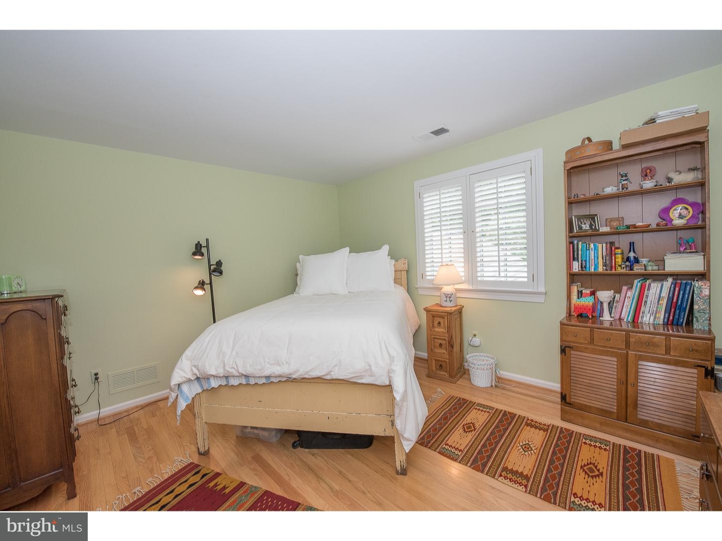 414 Gilpin Road Narberth, PA 19072 - Photo 21 of 25 a bedroom with a bed and a book shelf