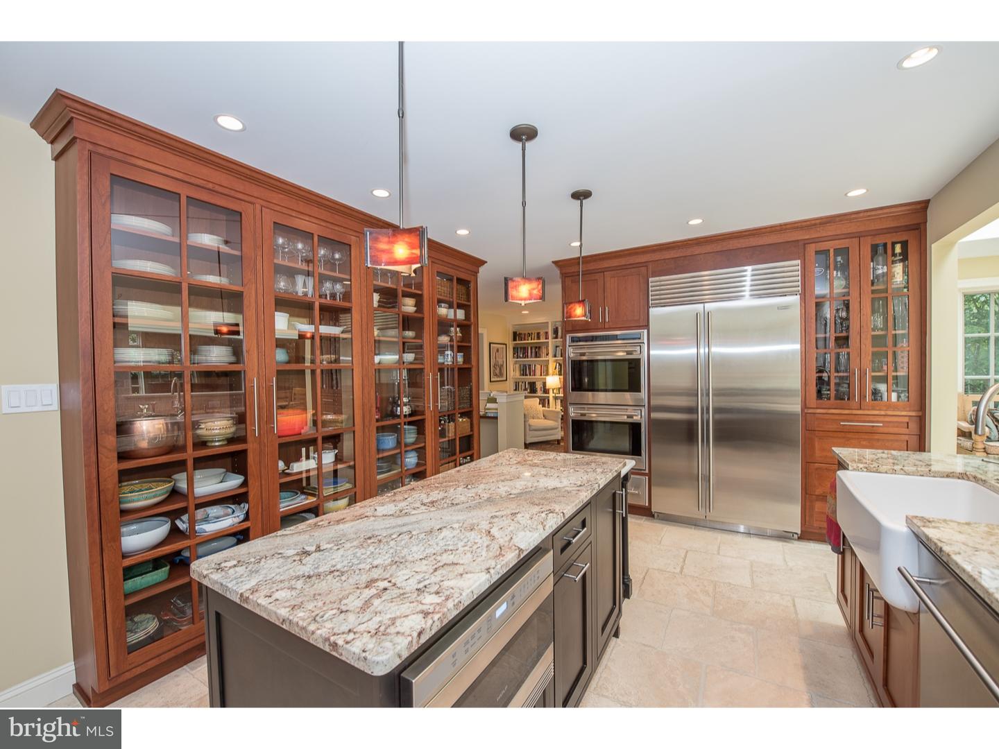 414 Gilpin Road Narberth, PA 19072 - Photo 8 of 25 a kitchen with stainless steel appliances kitchen island granite countertop a table and chairs in it