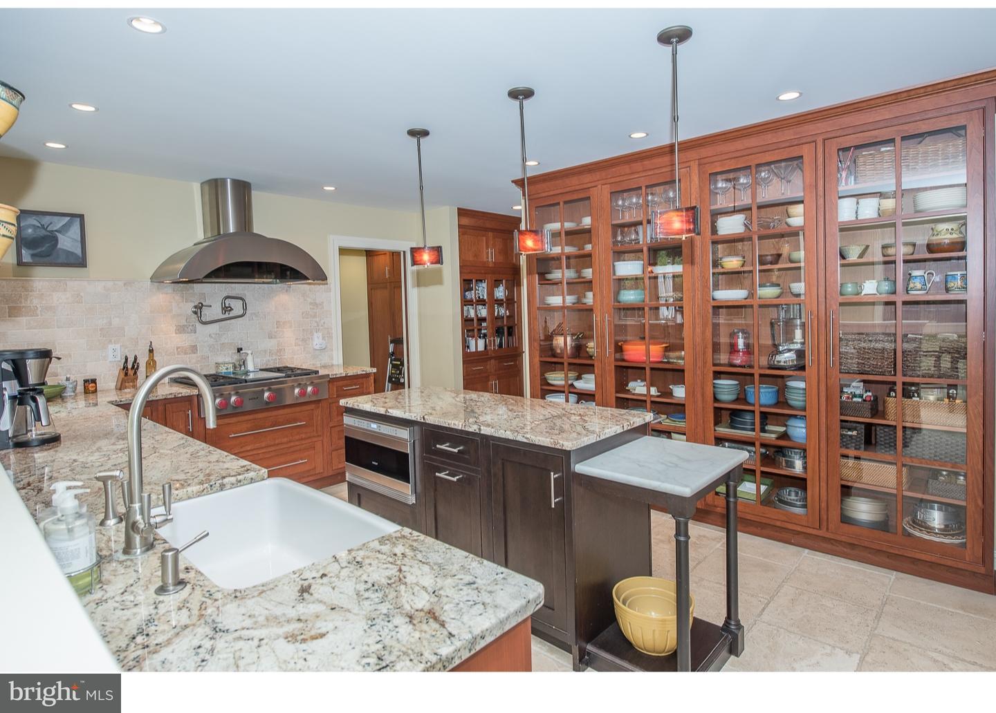 414 Gilpin Road Narberth, PA 19072 - Photo 9 of 25 a kitchen with stainless steel appliances kitchen island granite countertop a stove and cabinets
