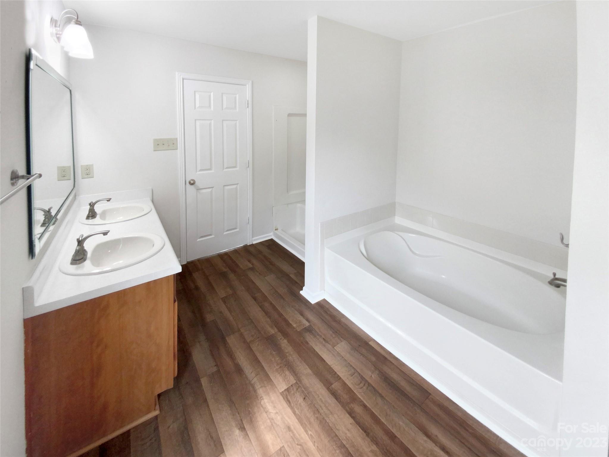 2518 Spring Breeze Way Monroe, NC 28110 - Photo 14 of 22 a bathroom with a tub sink and mirror