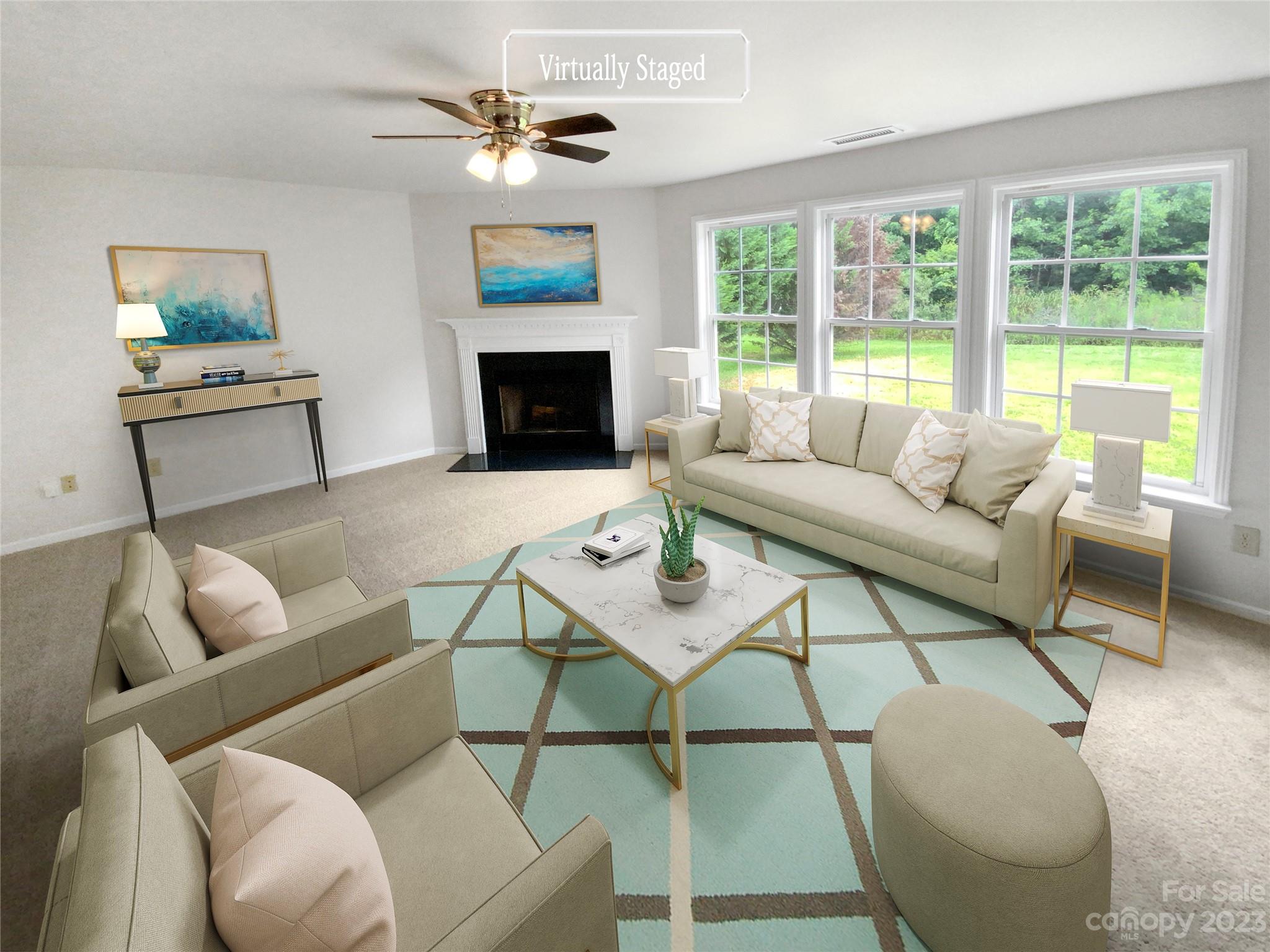 2518 Spring Breeze Way Monroe, NC 28110 - Photo 2 of 22 a living room with furniture a fireplace and a large window