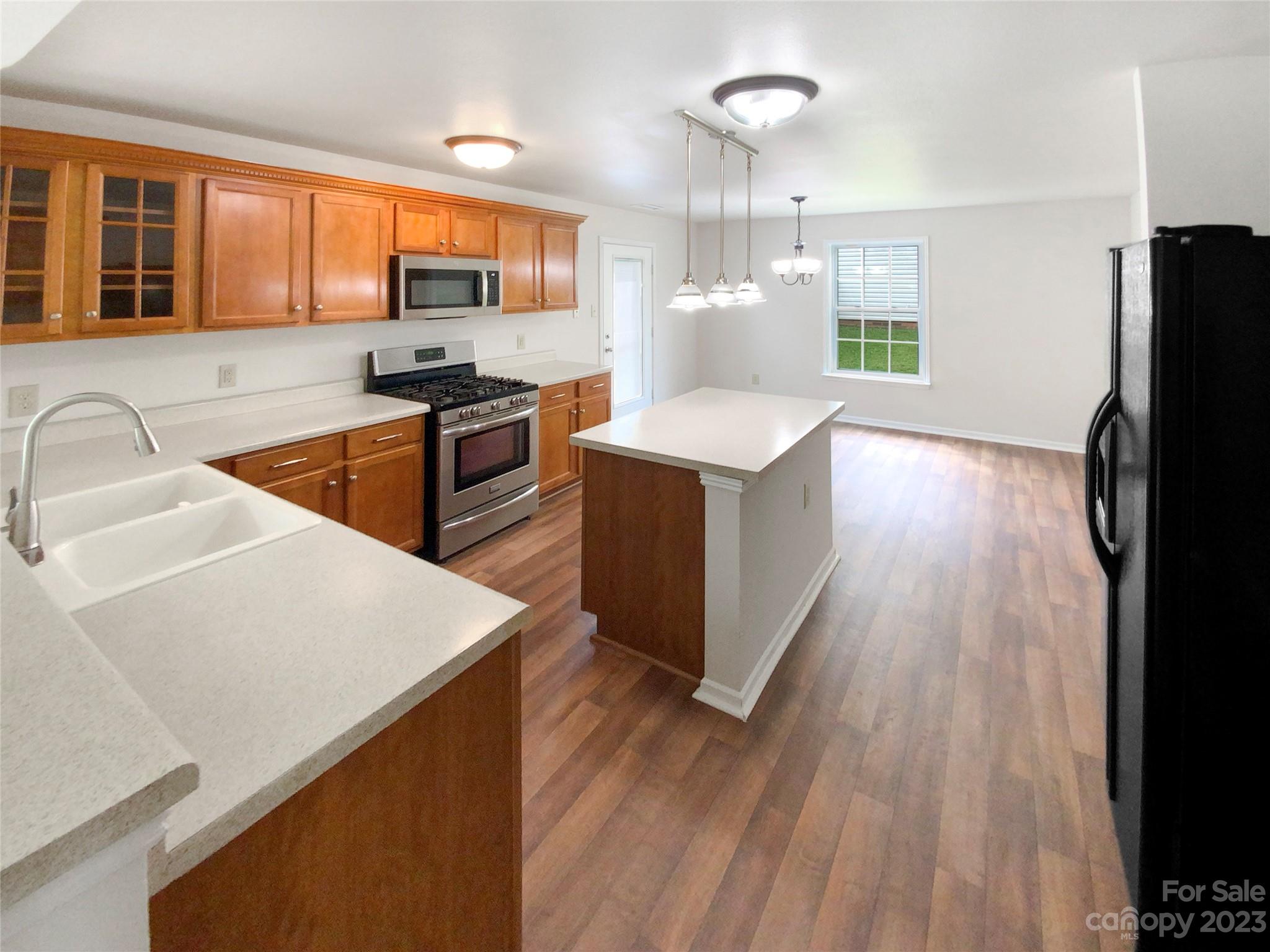 2518 Spring Breeze Way Monroe, NC 28110 - Photo 9 of 22 a kitchen with stainless steel appliances a sink stove and refrigerator