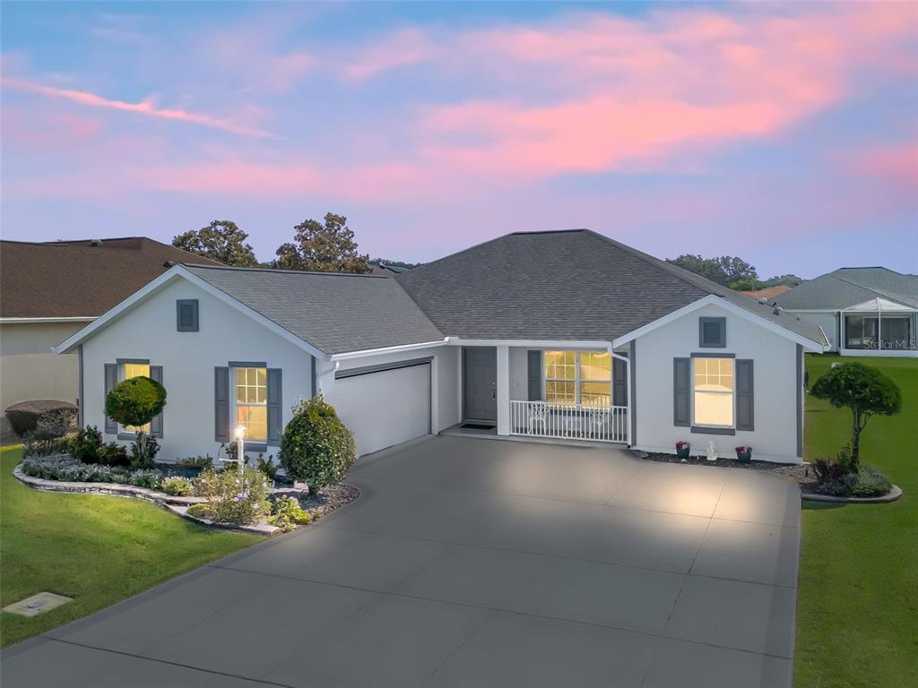 a front view of house with yard and green space