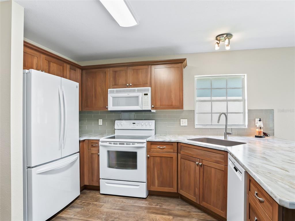 12321 Southeast 176th Loop Summerfield, FL 34491 - Photo 11 of 51 a kitchen with a white stove top oven and refrigerator