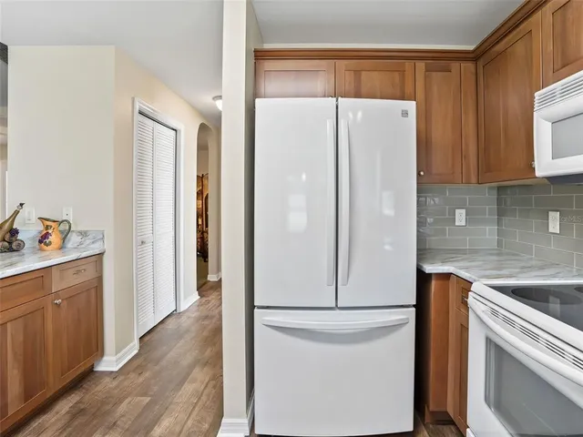 a white refrigerator freezer sitting inside of a kitchen
