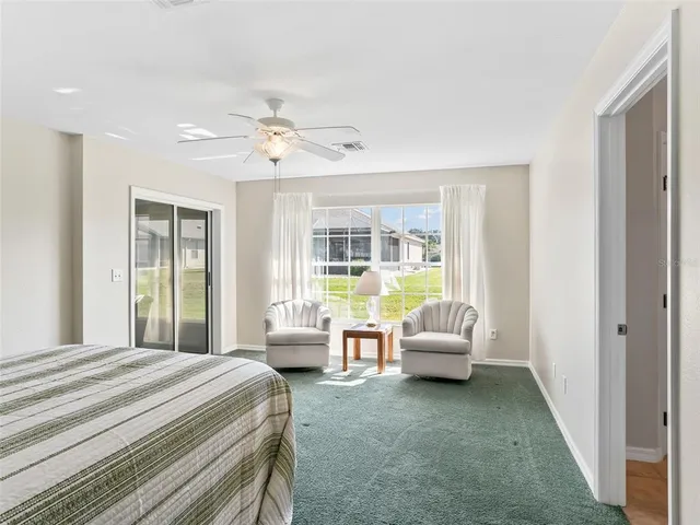 a bedroom with a bed and glass window