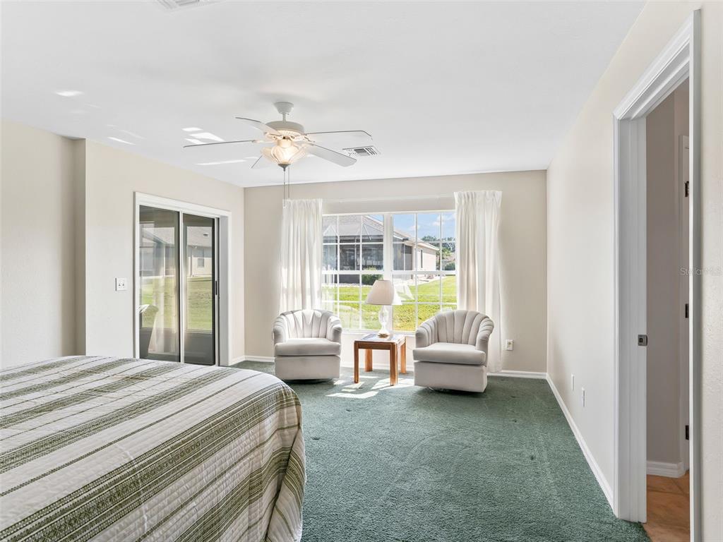 12321 Southeast 176th Loop Summerfield, FL 34491 - Photo 18 of 51 a bedroom with a bed and glass window