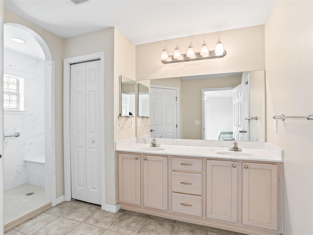 12321 Southeast 176th Loop Summerfield, FL 34491 - Photo 21 of 51 a bathroom with a sink vanity and a mirror