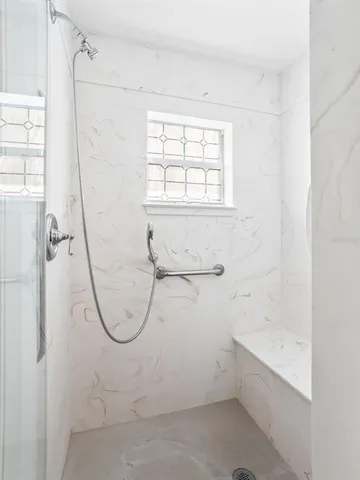 a bathroom with a bath tub with a shower