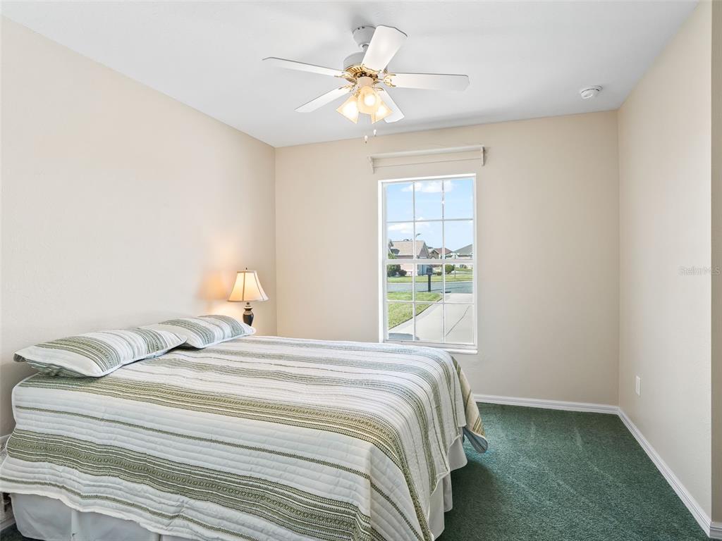 12321 Southeast 176th Loop Summerfield, FL 34491 - Photo 24 of 51 a bedroom with a bed and a chandelier