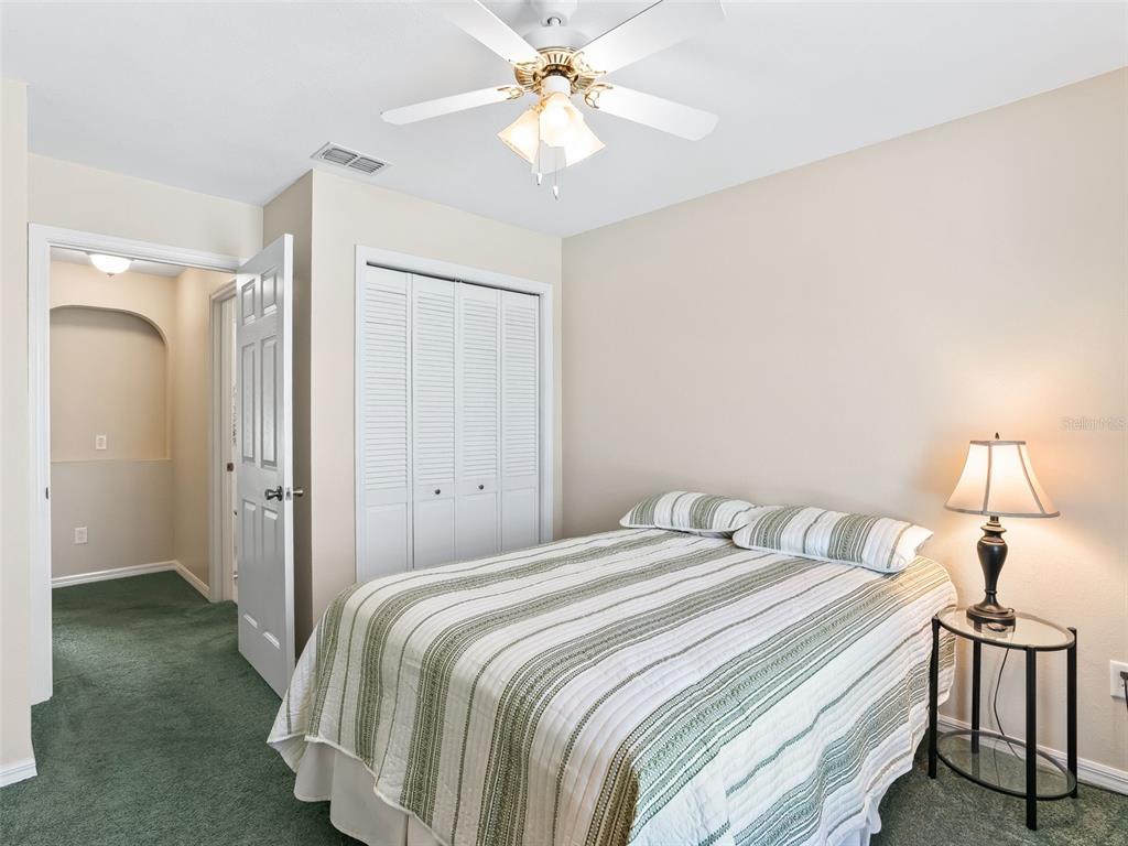 12321 Southeast 176th Loop Summerfield, FL 34491 - Photo 25 of 51 a bedroom with a bed and a chandelier