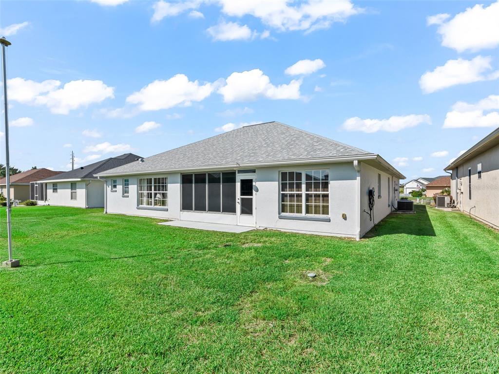 12321 Southeast 176th Loop Summerfield, FL 34491 - Photo 35 of 51 a view of a house with a yard and sitting area