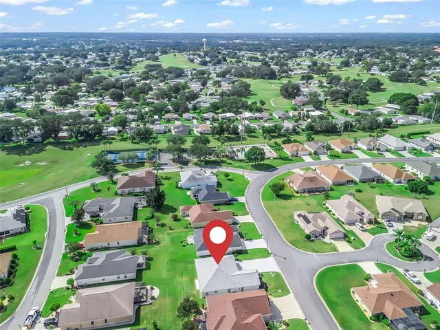 a front view of a house with a yard and potted plants