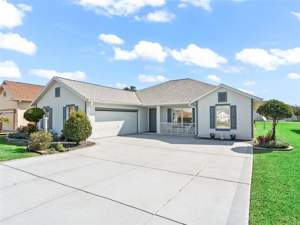 12321 Southeast 176th Loop Summerfield, FL 34491 - Photo 39 of 51 a front view of a house with a yard and potted plants